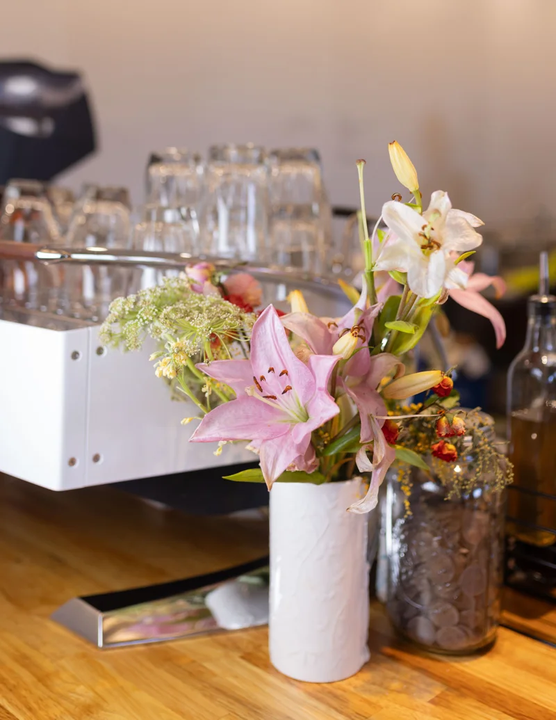 Flowers and the espresso machine, photographed by Lily
